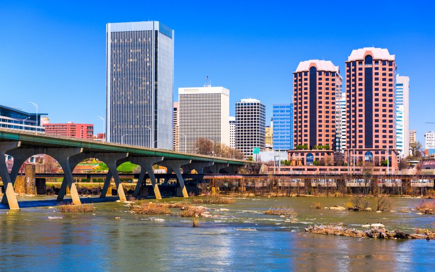A bridge over water in Richmond with buildings in the background